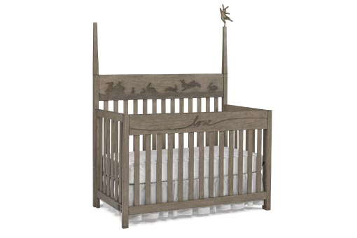 Warm grey baby crib with a dancing bunny on a spindle