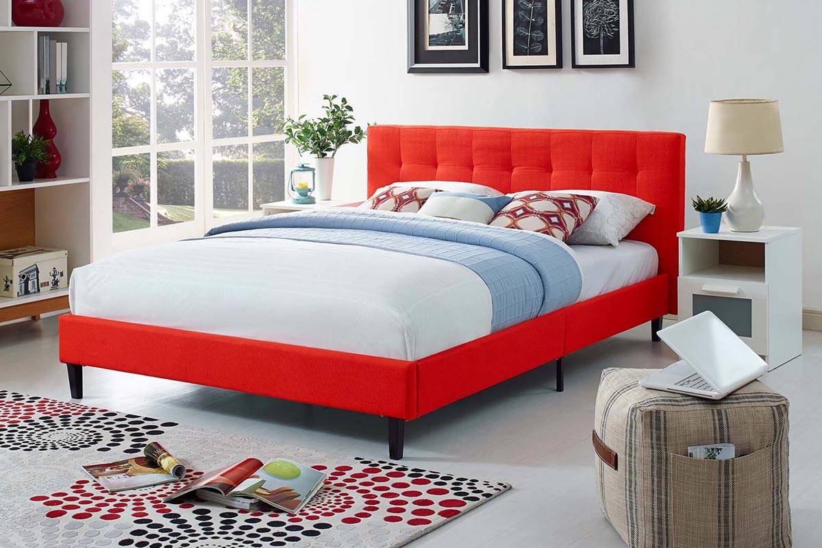 Bright red upholstered bed with tufted headboard