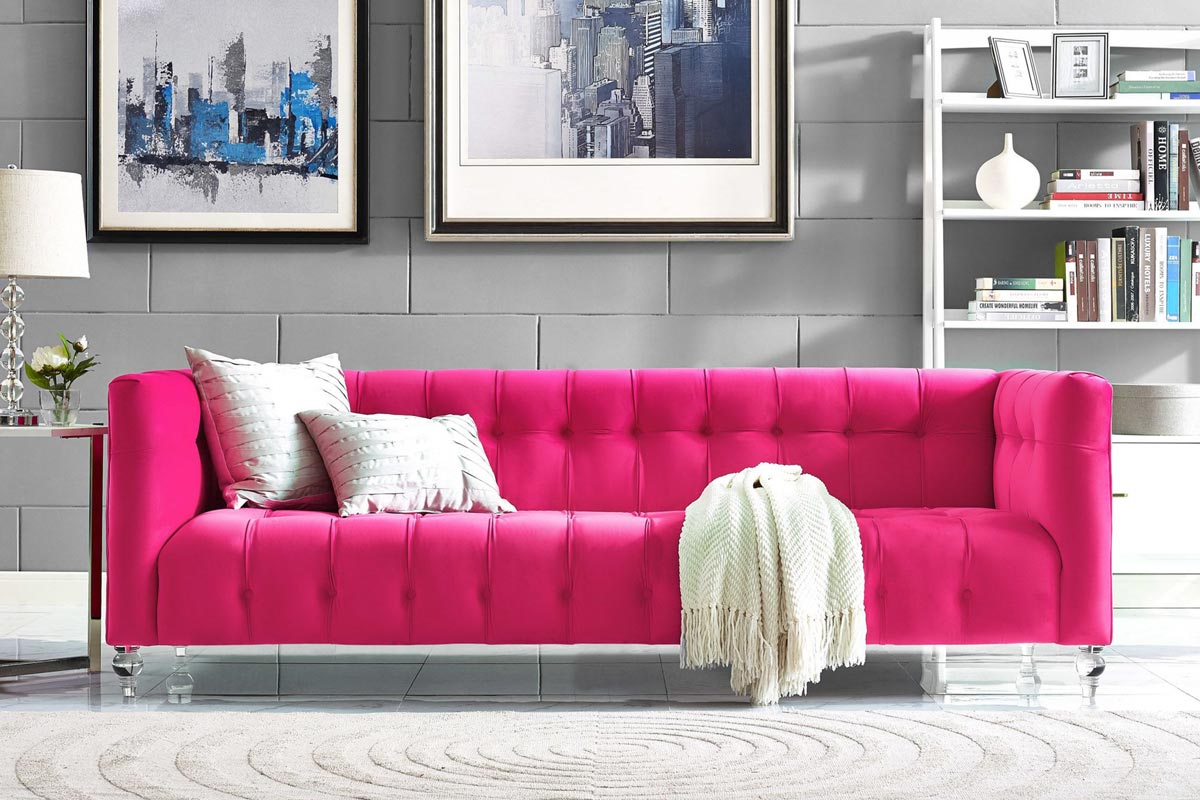 Hot pink tufted sofa in a grey room