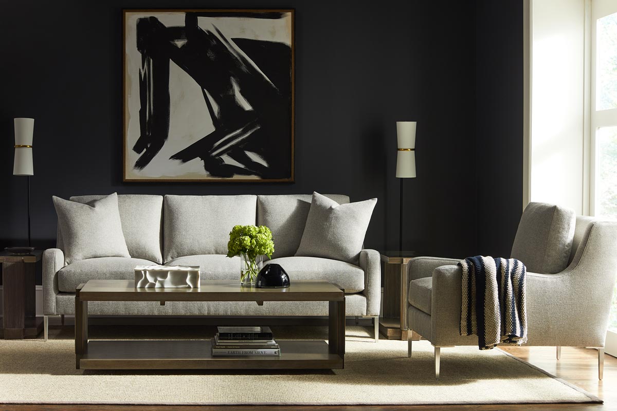 A living room set of furniture in light grey upholstery from Vanguard Furniture
